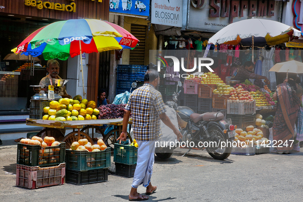 Merchants are selling fruits along the roadside in the East Fort in Thiruvananthapuram (Trivandrum), Kerala, India, on April 13, 2024. 