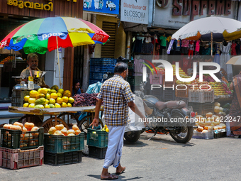 Merchants are selling fruits along the roadside in the East Fort in Thiruvananthapuram (Trivandrum), Kerala, India, on April 13, 2024. (