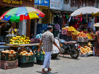 Merchants are selling fruits along the roadside in the East Fort in Thiruvananthapuram (Trivandrum), Kerala, India, on April 13, 2024. (