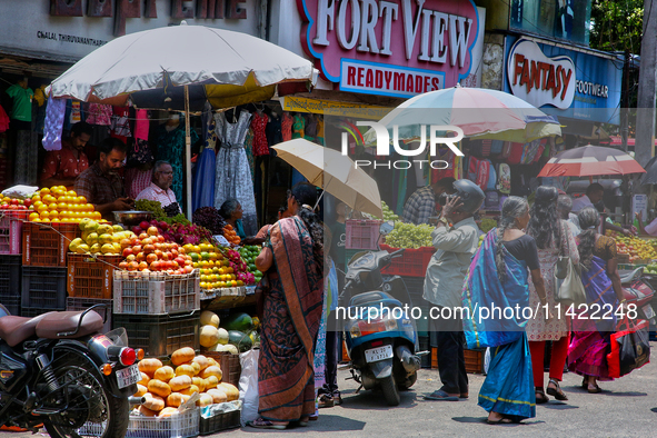 Merchants are selling fruits along the roadside in the East Fort in Thiruvananthapuram (Trivandrum), Kerala, India, on April 13, 2024. 