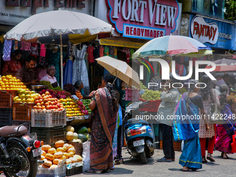 Merchants are selling fruits along the roadside in the East Fort in Thiruvananthapuram (Trivandrum), Kerala, India, on April 13, 2024. (