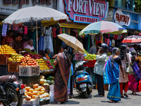 Merchants are selling fruits along the roadside in the East Fort in Thiruvananthapuram (Trivandrum), Kerala, India, on April 13, 2024. (