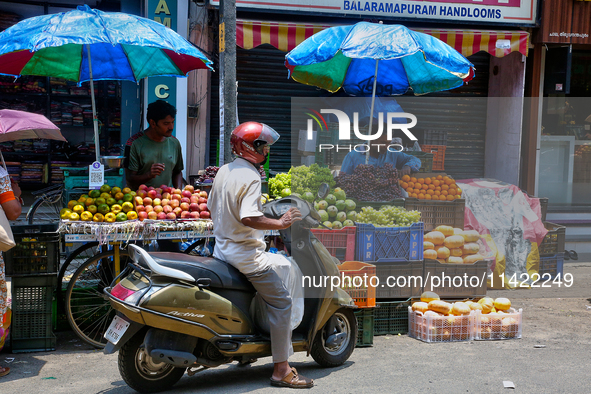 Merchants are selling fruits along the roadside in the East Fort in Thiruvananthapuram (Trivandrum), Kerala, India, on April 13, 2024. 