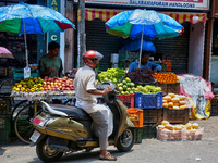 Merchants are selling fruits along the roadside in the East Fort in Thiruvananthapuram (Trivandrum), Kerala, India, on April 13, 2024. (