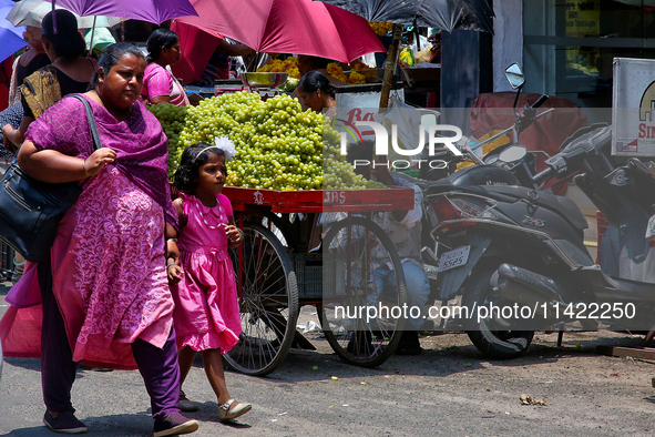 Merchants are selling fruits from small carts along the roadside in the East Fort in Thiruvananthapuram (Trivandrum), Kerala, India, on Apri...