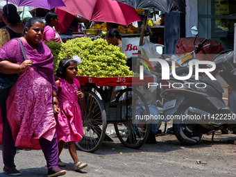 Merchants are selling fruits from small carts along the roadside in the East Fort in Thiruvananthapuram (Trivandrum), Kerala, India, on Apri...