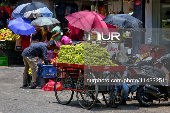 Merchants are selling fruits from small carts along the roadside in the East Fort in Thiruvananthapuram (Trivandrum), Kerala, India, on Apri...