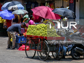 Merchants are selling fruits from small carts along the roadside in the East Fort in Thiruvananthapuram (Trivandrum), Kerala, India, on Apri...