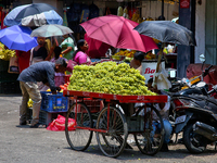 Merchants are selling fruits from small carts along the roadside in the East Fort in Thiruvananthapuram (Trivandrum), Kerala, India, on Apri...