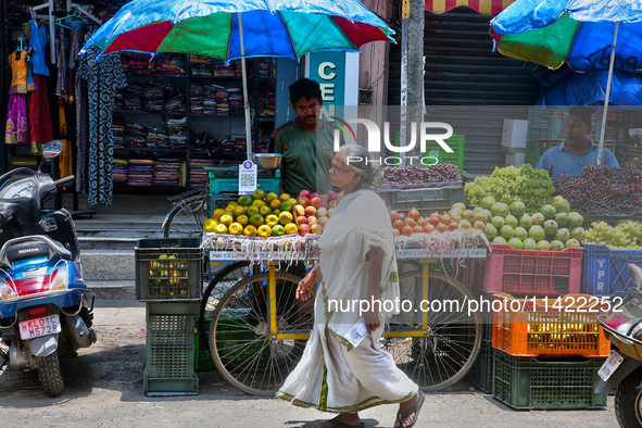 Merchants are selling fruits from small carts along the roadside in the East Fort in Thiruvananthapuram (Trivandrum), Kerala, India, on Apri...