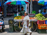 Merchants are selling fruits from small carts along the roadside in the East Fort in Thiruvananthapuram (Trivandrum), Kerala, India, on Apri...