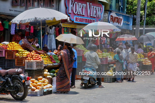 Merchants are selling fruits along the roadside in the East Fort in Thiruvananthapuram (Trivandrum), Kerala, India, on April 13, 2024. 