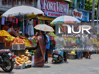 Merchants are selling fruits along the roadside in the East Fort in Thiruvananthapuram (Trivandrum), Kerala, India, on April 13, 2024. (