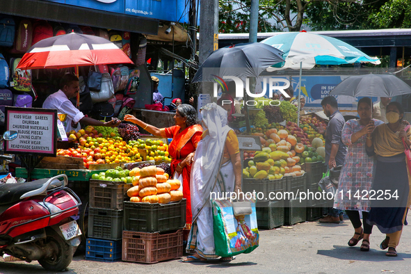 Merchants are selling fruits along the roadside in the East Fort in Thiruvananthapuram (Trivandrum), Kerala, India, on April 13, 2024. 