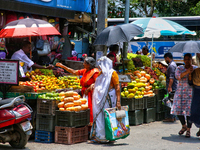 Merchants are selling fruits along the roadside in the East Fort in Thiruvananthapuram (Trivandrum), Kerala, India, on April 13, 2024. (