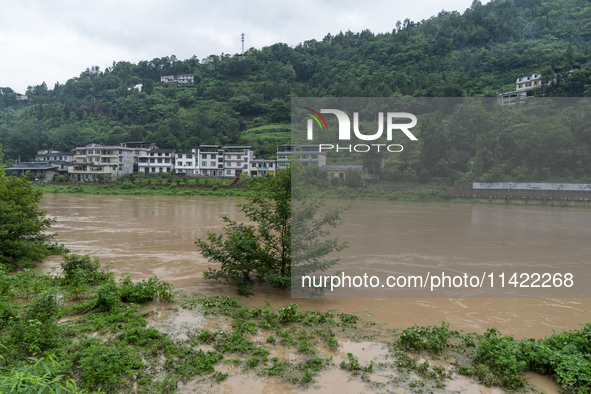 Floodwaters are inundating farmland and trees along the banks of the Tunpu section of Qingjiang River in Enshi, Hubei province, China, on Ju...