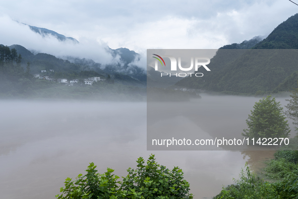 Floodwaters are inundating farmland and trees along the banks of the Tunpu section of Qingjiang River in Enshi, Hubei province, China, on Ju...