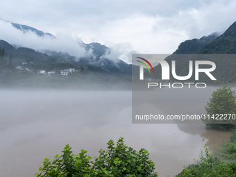 Floodwaters are inundating farmland and trees along the banks of the Tunpu section of Qingjiang River in Enshi, Hubei province, China, on Ju...