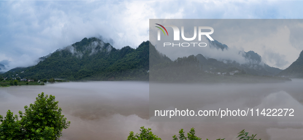 Floodwaters are inundating farmland and trees along the banks of the Tunpu section of Qingjiang River in Enshi, Hubei province, China, on Ju...