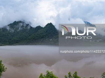 Floodwaters are inundating farmland and trees along the banks of the Tunpu section of Qingjiang River in Enshi, Hubei province, China, on Ju...