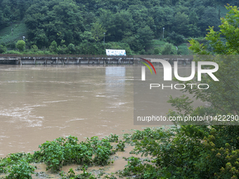 Floodwaters are inundating farmland and trees along the banks of the Tunpu section of Qingjiang River in Enshi, Hubei province, China, on Ju...