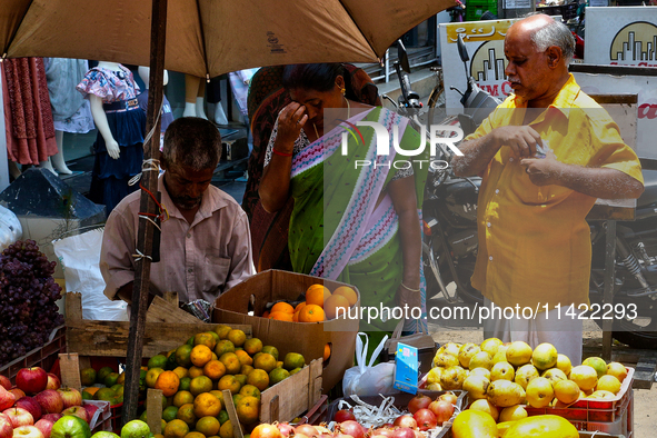 Merchants are selling fruits from small carts along the roadside in the East Fort in Thiruvananthapuram (Trivandrum), Kerala, India, on Apri...