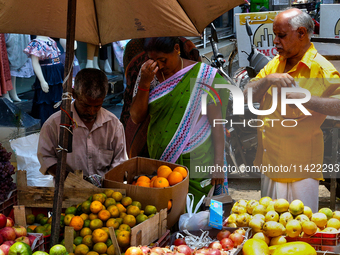 Merchants are selling fruits from small carts along the roadside in the East Fort in Thiruvananthapuram (Trivandrum), Kerala, India, on Apri...