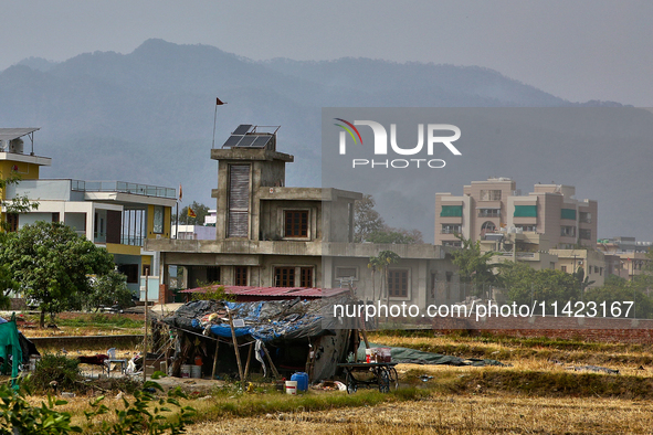 A farm laborer is living in a small makeshift house in Haldwani, Uttarakhand, India, on April 23, 2024. 