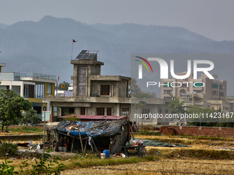 A farm laborer is living in a small makeshift house in Haldwani, Uttarakhand, India, on April 23, 2024. (