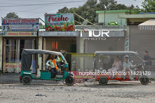 Auto-rickshaws are parking outside shops in Haldwani, Uttarakhand, India, on April 23, 2024. 