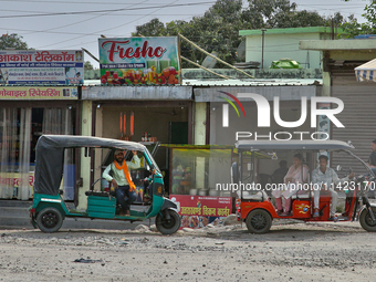 Auto-rickshaws are parking outside shops in Haldwani, Uttarakhand, India, on April 23, 2024. (