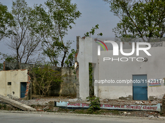 The remains of a building are being destroyed in Haldwani, Uttarakhand, India, on April 23, 2024. (