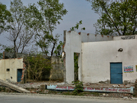 The remains of a building are being destroyed in Haldwani, Uttarakhand, India, on April 23, 2024. (