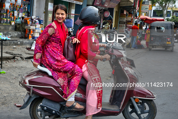 Women are traveling to a wedding party in Haldwani, Uttarakhand, India, on April 23, 2024. 