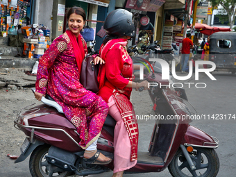 Women are traveling to a wedding party in Haldwani, Uttarakhand, India, on April 23, 2024. (