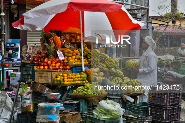 A man is purchasing bananas at a roadside fruit stand in Haldwani, Uttarakhand, India, on April 23, 2024. 