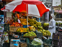 A man is purchasing bananas at a roadside fruit stand in Haldwani, Uttarakhand, India, on April 23, 2024. (