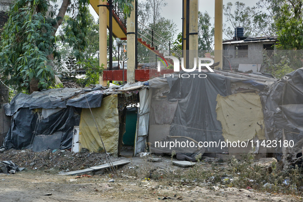 A poor family is building a house along the roadside from scrap items in Haldwani, Uttarakhand, India, on April 23, 2024. 