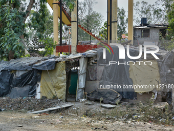 A poor family is building a house along the roadside from scrap items in Haldwani, Uttarakhand, India, on April 23, 2024. (