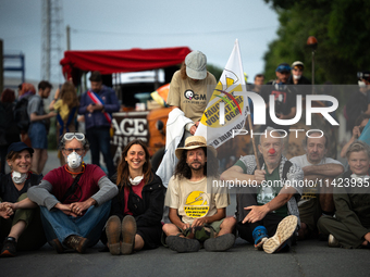 Demonstrators are sitting in front of the Atlantic port of La Rochelle in western France, on July 20, 2024, during a demonstration against t...