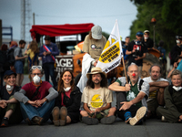 Demonstrators are sitting in front of the Atlantic port of La Rochelle in western France, on July 20, 2024, during a demonstration against t...