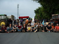 Demonstrators are sitting in front of the Atlantic port of La Rochelle in western France, on July 20, 2024, during a demonstration against t...