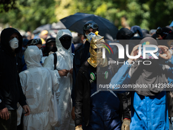 Protesters are walking among the houses of a village during a demonstration against the construction of a giant water reservoir (mega-bassin...