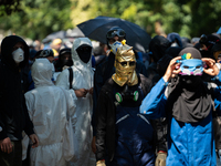 Protesters are walking among the houses of a village during a demonstration against the construction of a giant water reservoir (mega-bassin...