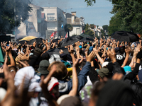 Protesters are walking among the houses of a village during a demonstration against the construction of a giant water reservoir (mega-bassin...