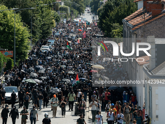 Protesters are walking among the houses of a village during a demonstration against the construction of a giant water reservoir (mega-bassin...