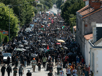 Protesters are walking among the houses of a village during a demonstration against the construction of a giant water reservoir (mega-bassin...