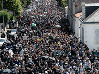 Protesters are walking among the houses of a village during a demonstration against the construction of a giant water reservoir (mega-bassin...