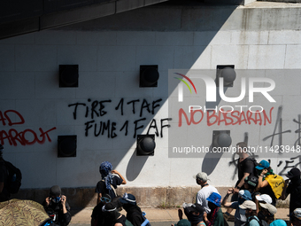 Protesters are walking among the houses of a village during a demonstration against the construction of a giant water reservoir (mega-bassin...