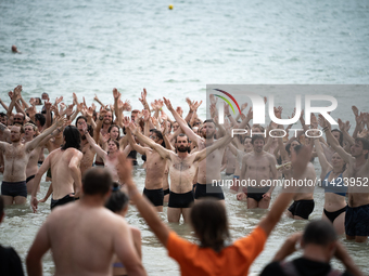 Demonstrators are celebrating their mobilization by swimming in the ocean during a demonstration against the construction of giant water res...